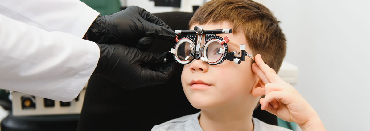 A young boy is fitted with a medical device testing his vision